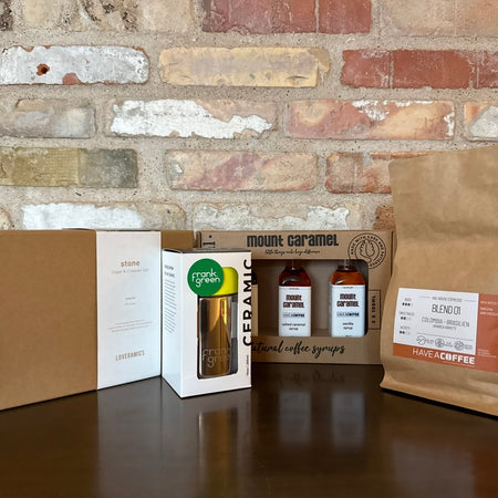 Adventskalender med kaffeprodukter, sirup, kop og bønner til kaffeconnaisseuren.