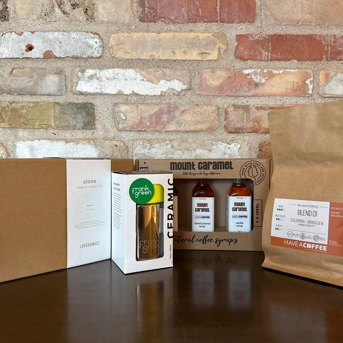 Adventskalender med kaffeprodukter, sirup, kop og bønner til kaffeconnaisseuren.